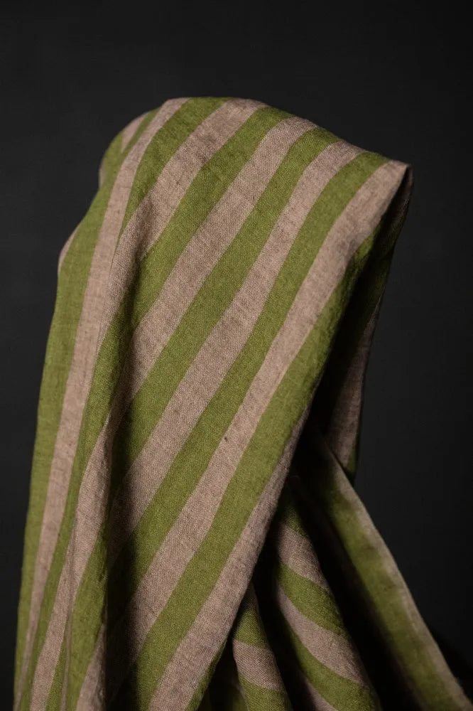 A muted green and pale pink striped linen fabric